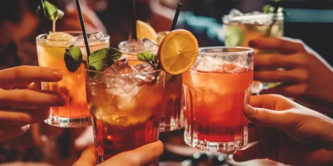 A circle of cocktail glasses, held together in a circle for a toast (Web Optimized)