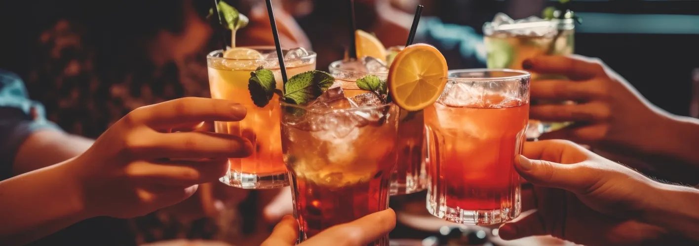 A circle of cocktail glasses, held together in a circle for a toast (Web Optimized)