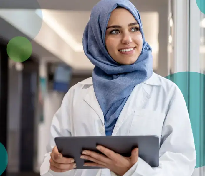 Female medical professional with tablet looking out window