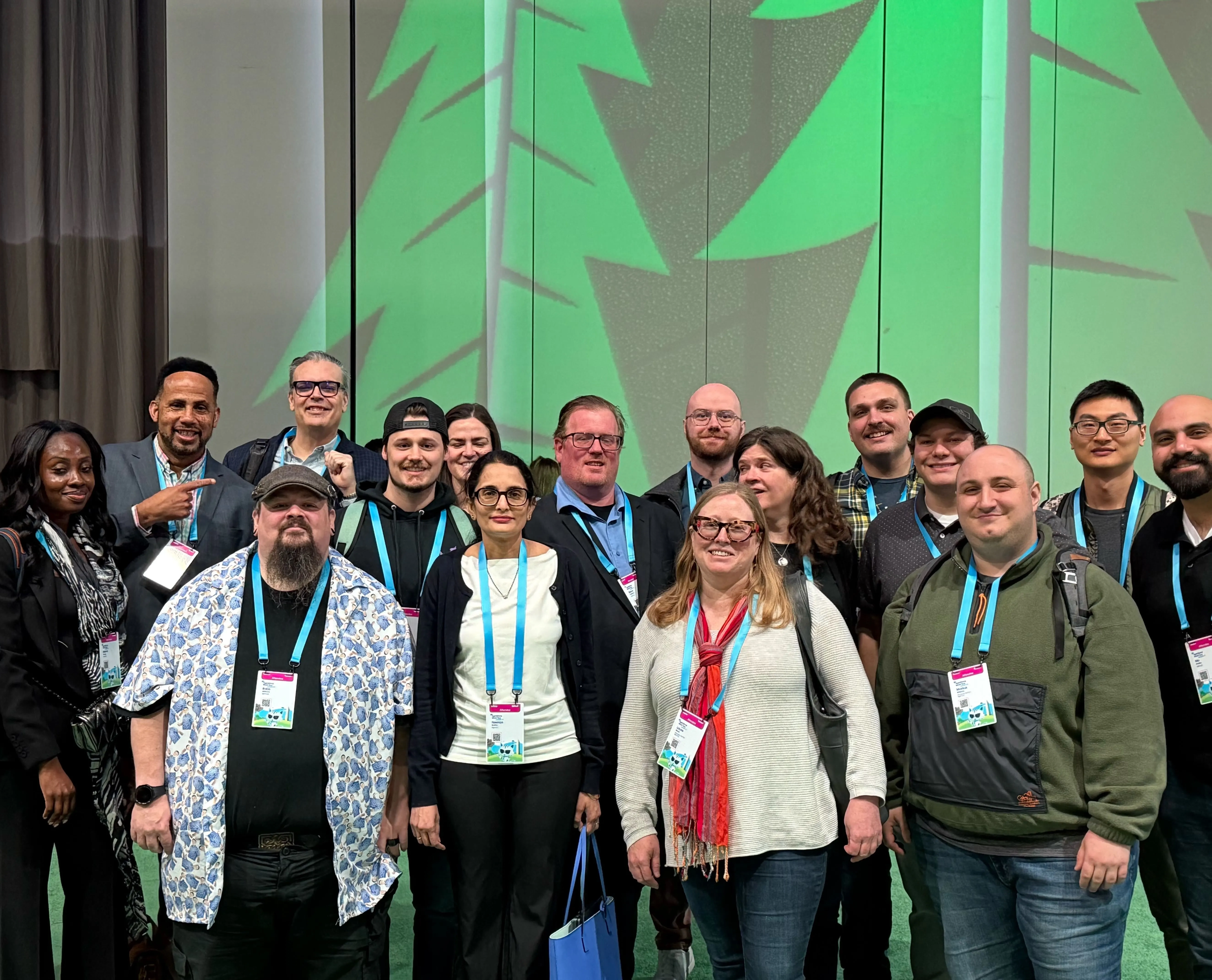 Group of AgencyQ Staff in front of a backdrop of stylized trees (Web Optimized)